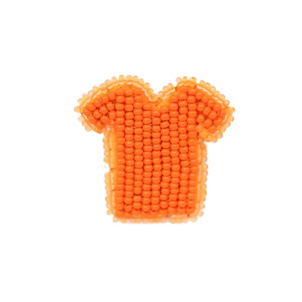 beautifully beaded brooch that looks like a tiny tshirt. Lighter orange beads on the outer rim, darker for the interior beads.