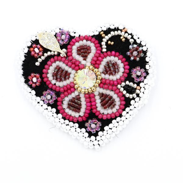 beaded heart brooch with white border and pink flower, it is a photo of the brooch for display purposes.