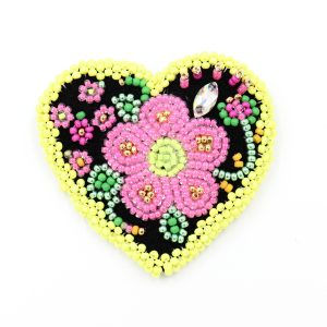 beaded heart brooch with yellow border and pink flower, it is a photo of the brooch for display purposes.