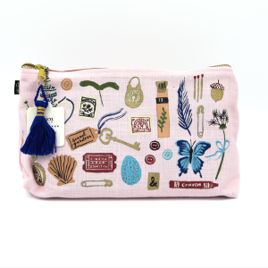 Pink cosmetic bag with odds and ends drawn all over it. background of photo is white.