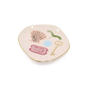 Small trinket tray in light pink with whimiscal designs on it.