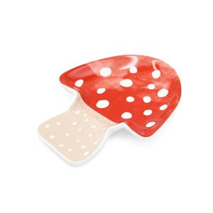 Mushroom shaped spoon rest with a red top and white dots on it like a toadstool.