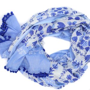 Image of a scarf coiled up on a white background, patterned with three colours of blue and some white flowers and colour blocked stripes.