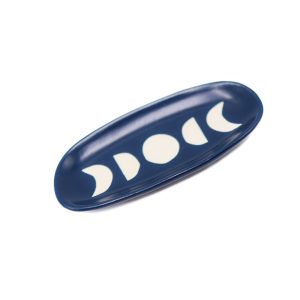 small oval trinket dish in navy blue with white moon designs on it
