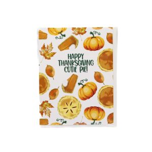 white card with white envelope, the card is covered in orange items, including pumpkins, slices of pumpkin pie with whipped cream, and fallen leaves.