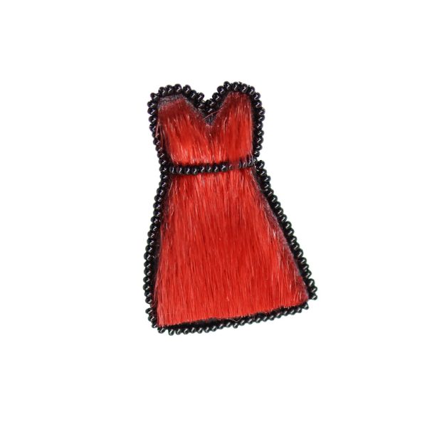 A dress shaped brooch beaded around the edges with black beads. The fur is red and about a cm long.