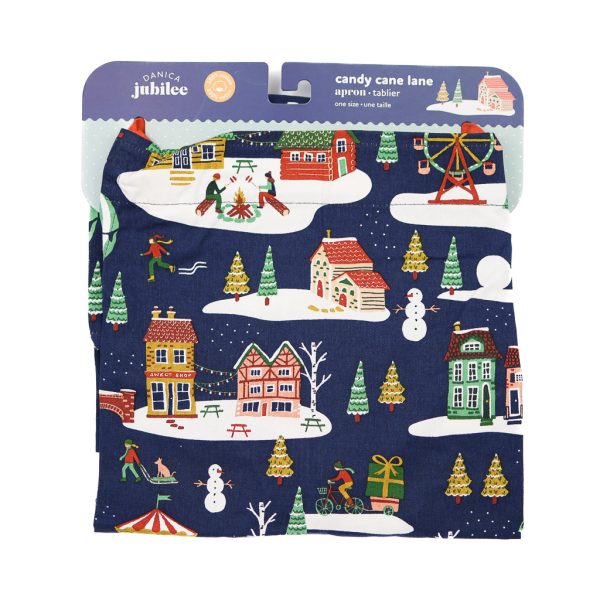 mainly navy blue apron with patterns of winter scenes. The straps are red, and it is displayed on a headless and armless mannequin.