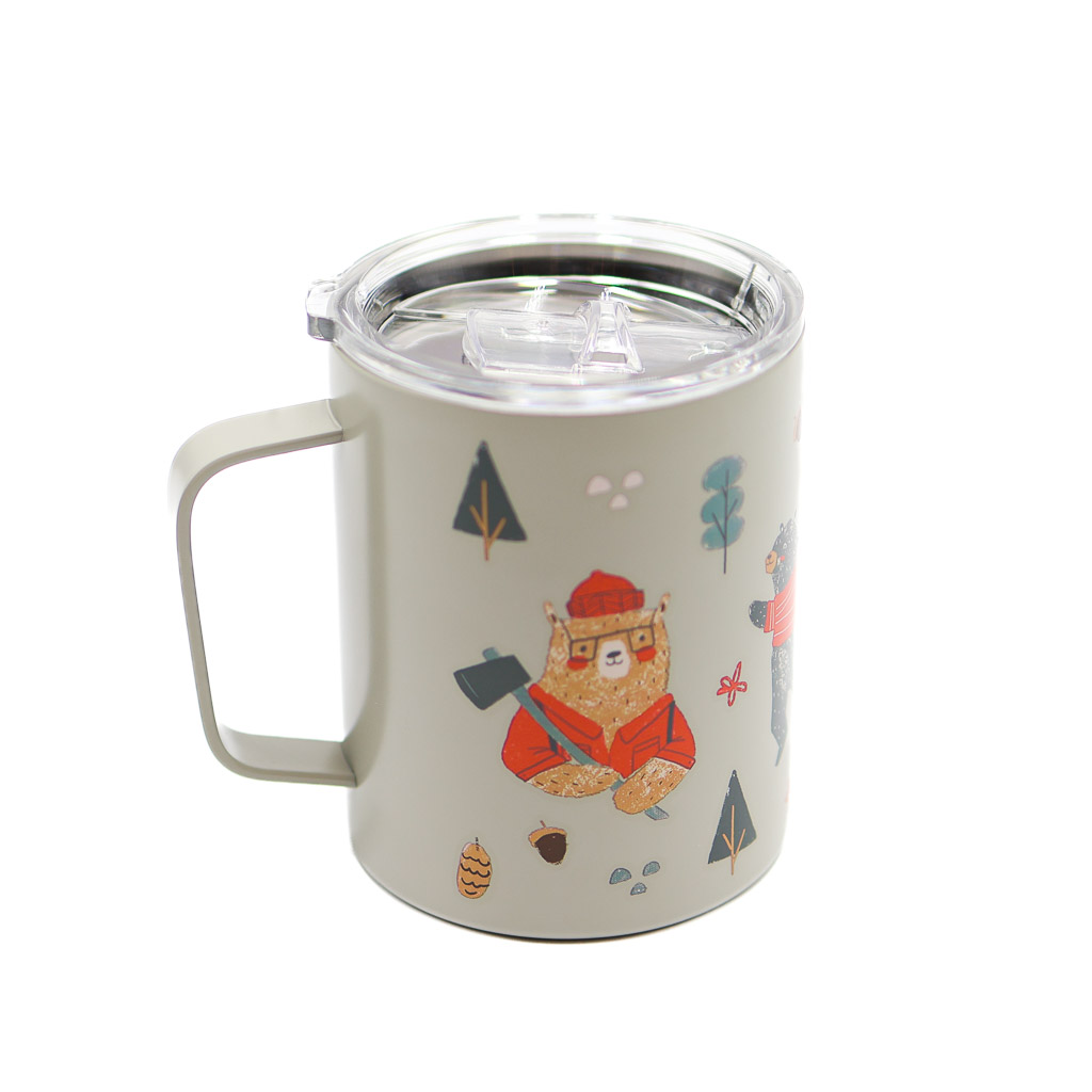grey 12 oz mug with the handle facing to the right and displaying a bear in a hat and sweater amongst fir trees.