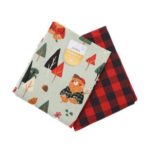 two folded tea towels featuring a patterned grey towel with bears and trees on it, and the other is red and black buffalo plaid.