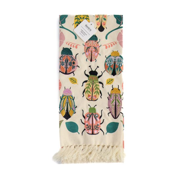 beige tea towel with embroidered beetles and lovely tassels