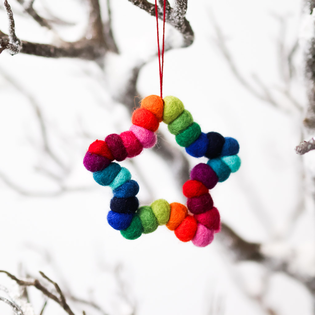 felt rainbow star ornament rainbow pompoms shaped to look like the outline of a star