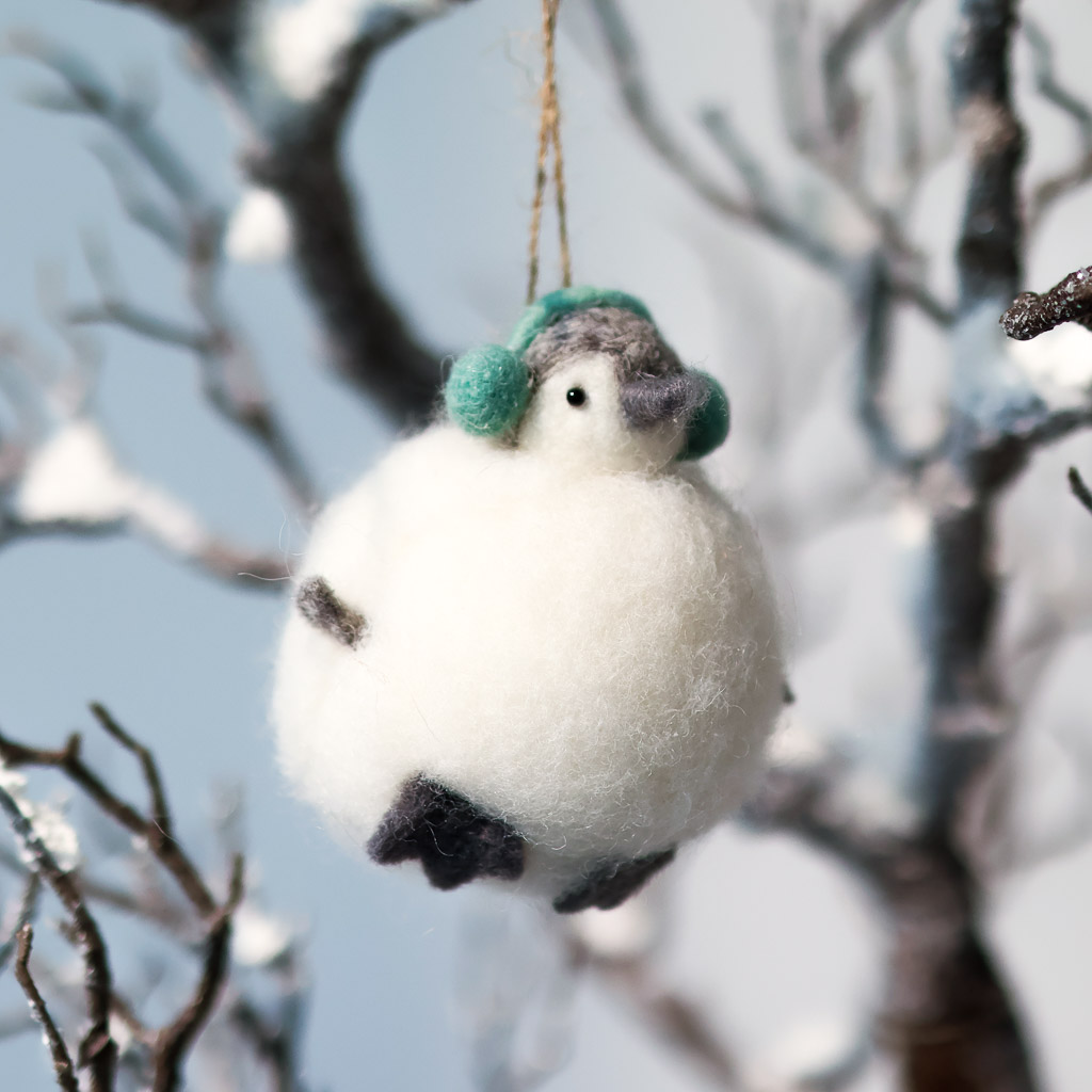 felt snowball bird wooly snowball ornament with a penguin face coming out the top and wearing earmuffs
