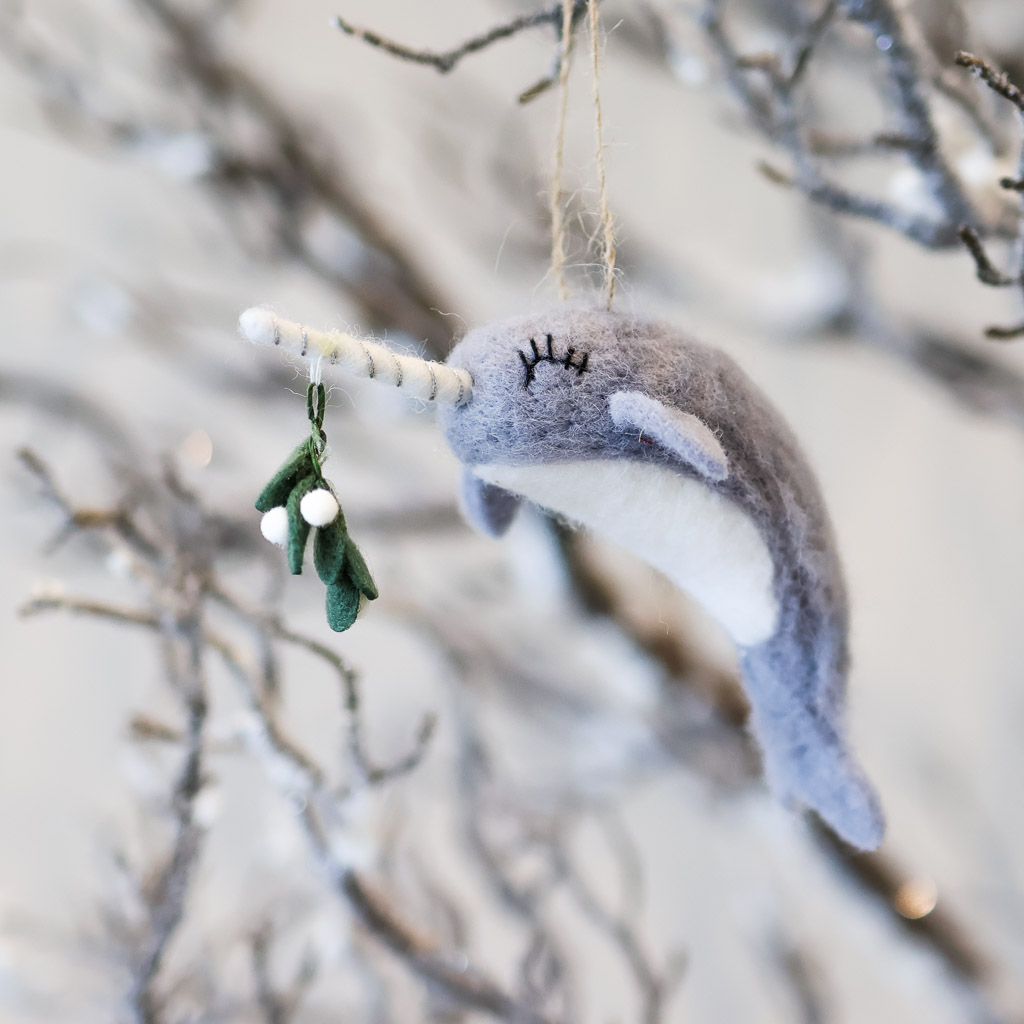 mistletoe narwhal ornament option 2 adorably lush eyelashes on this grey felt narwhal, it's holding the mistletoe on the end of its horn.